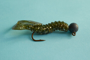 Fishing lures. Fishing Twister close up on blue background