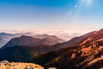 View of Himalayas mountain range with visible silhouettes through the colorful fog from Khalia top...