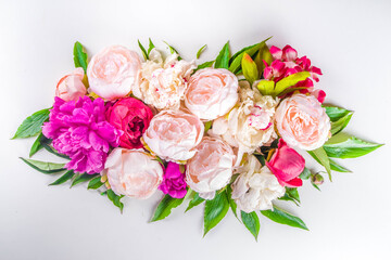 Flat lay of flowers and green leaves