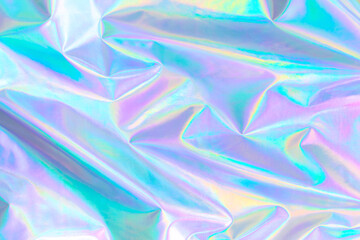 Abstract Modern pastel colored holographic background in 80s style. Crumpled iridescent foil textile real texture. Synthwave. Vaporwave style. Retrowave, retro futurism, webpunk