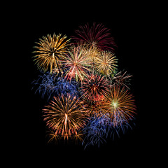 Fototapeta premium Colourful fireworks light up on sky with dazzling display on drak blue sky background. Event and celebrations background concept