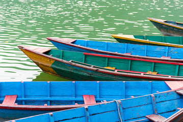 Colourful attraction Boats docked at the Phewa lake in Pokhara, Nepal. Selective focus at middle boat