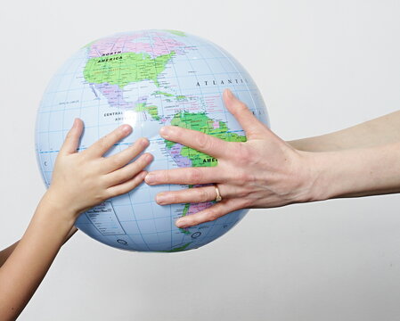 hand with globe on earth day on grey background stock photo