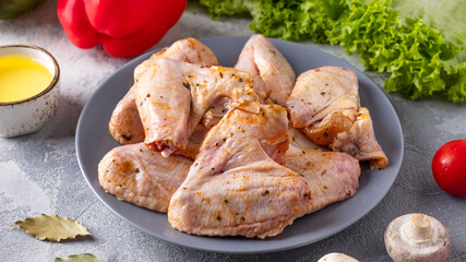 Raw chicken wings marinated in spices