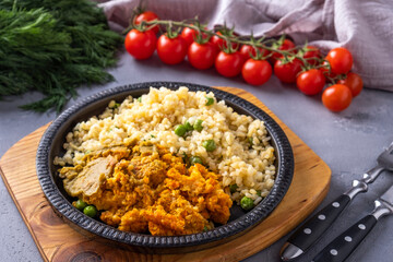 Carrot balls garnish with bulgur and green peas served with fork knife