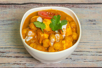 Chole/channa Paneer curry made using boiled chickpea with cottage cheese with spices. Popular North Indian recipe. served in a bowl or serving pan.