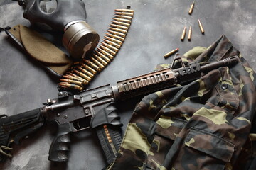 Assault rifle (M4A1)  with ammunition on camouflage uniform,and military equipment for army,bullets...