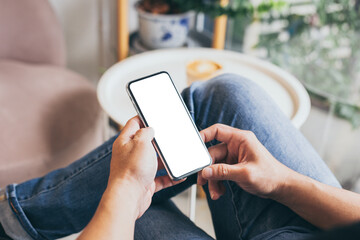 cell phone mockup blank white screen.man hand holding texting using mobile on desk at coffee shop.background empty space for advertise.work people contact marketing business,technology