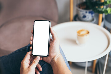 cell phone mockup blank white screen.man hand holding texting using mobile on desk at coffee shop.background empty space for advertise.work people contact marketing business,technology