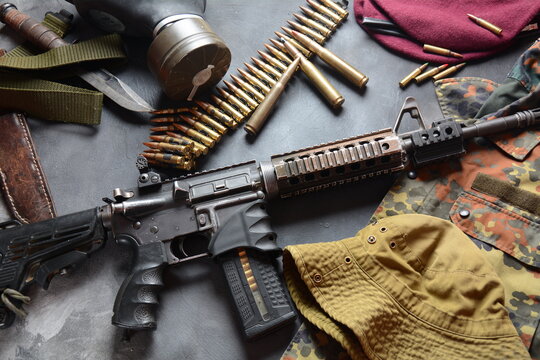 Assault rifle (M4A1)  with ammunition on camouflage uniform,and military equipment for army,bullets and a magazine 