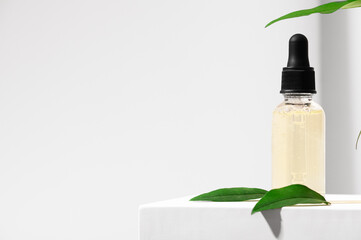 Natural skincare product in glass bottle with dropper. Serum for woman facial skin. Herbal mineral...
