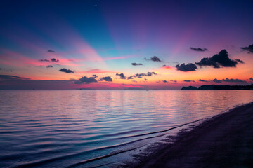 Fototapeta na wymiar Bright beautiful landscape. Lilac sunset with pink clouds on tropical beach