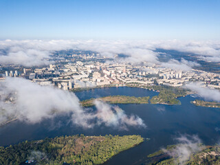 Flying over autumn clouds in Kiev. Sunny morning.