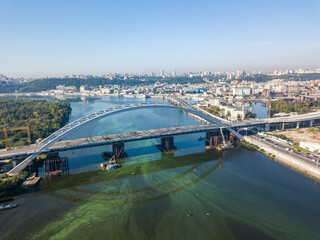 Fototapeta premium Aerial drone view. A cable-stayed bridge under construction across the Dnieper River in Kiev.