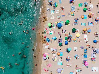 Fototapeta na wymiar Aerial Ocean Beach Photography, People And Umbrellas On Seaside Beach