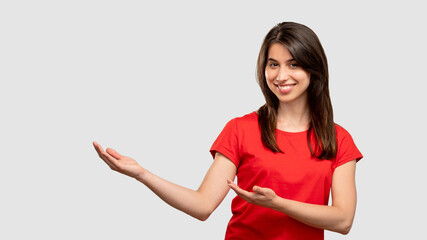 Fototapeta na wymiar Pointing hand. Text message. Happy woman showing copy space. Looking at camera isolated on neutral. Follow gesture. Education courses. Important information. Advertising background