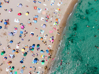 Fototapeta na wymiar Aerial Beach Photography, People And Colorful Umbrellas On Seaside Beach