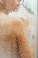 Young woman taking shower. Concept of simple pleasures, relaxing and healthcare