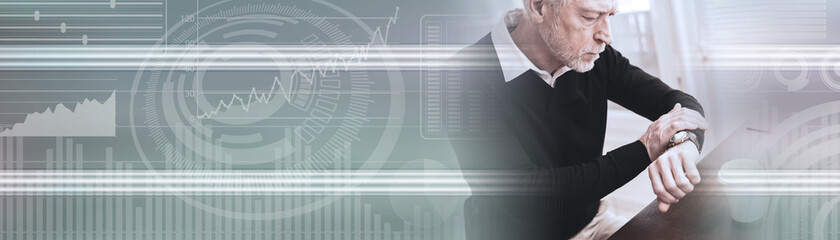 Businessman checking time on his wrist watch; panoramic banner