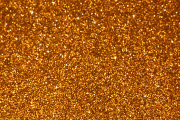 Golden abstract defocused bokeh background with stars. Sparkling texture