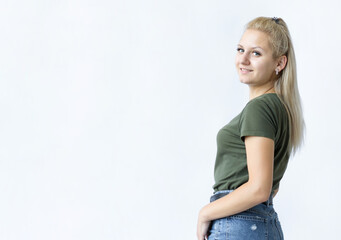 Pretty smiling joyfully female with fair hair, looking with satisfaction at camera, being happy. Beautiful woman isolated against blank studio wall.