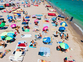 Aerial View Of People And Colorful Umbrellas On Ocean Seaside Beach In Summer