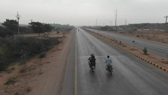 Aerial Following Motorbike On M9 Motorway In Pakistan. Follow Shot