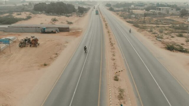 Aerial Following Traffic On Karachi to Hyderabad Motorway. Follow Shot