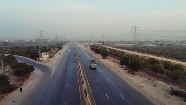 Traffic Travelling On Karachi to Hyderabad Motorway. Aerial Follow Shot