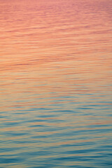 Background, backdrop of sunrise sunset colors on water at lake balaton rainbow colors from blue to red in smooth transition