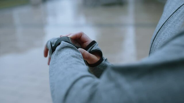 Close-up of a woman monitoring her fitness progress on her smartwatch. Woman checking time on her wristwatch.
