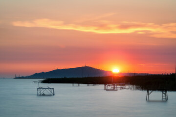 Lake Balaton at sunrise sunset near fonyód with mountain in the background. Tourism in Hungary...