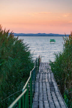 Lake Balaton at sunrise sunset near fony&oacute;d with mountain in the background. Tourism in Hungary vacation at the lake in the summer, fishing swimming