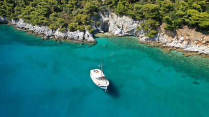 Obraz premium Aerial drone photo of beautiful cave with crystal clear turquoise sea in island of Skopelos visited by boat, Sporades, Greece