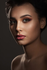 portrait of a beautiful brunette girl with a sophisticated professional visage with full lips and gray-green eyes