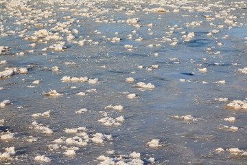 Sparkling ice texture or background. Ice hummock on Frozen River in winter sunny day.