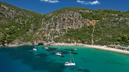 Obraz premium Aerial drone photo of popular crystal clear turquoise beach of Limnonari a safe sail boat anchorage, Skopelos island, Sporades, Greece