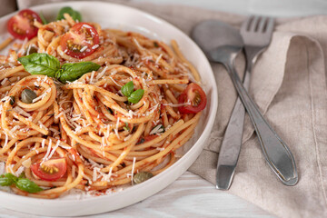 spaghetti with tomato sauce, basil and parmesan