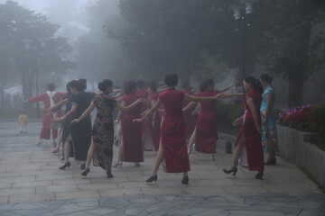 Women dancing in the fog