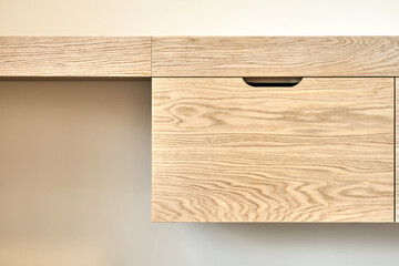 Modern furniture close-up. Wall mounted wooden dressing table in contemporary bedroom