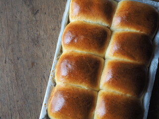 Golden brown baked bread bun in baking tray