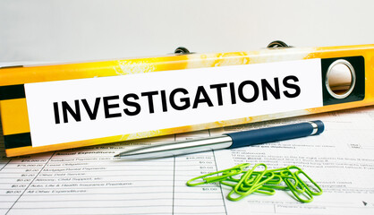 Text Investigations on the folder that is located on the financial reports with blue pen and green...