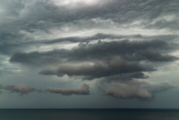 Fototapeta na wymiar Clouds gather over the sea before a thunderstorm near the coast in Crimea .