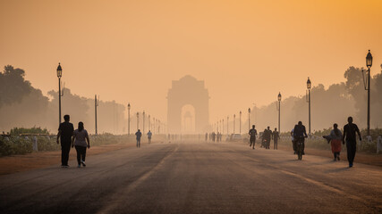 Silhouette of triumphal arch architectural style war memorial during hazy morning. Pollution level rises and causes smog in autumn season due stagnant winds. - obrazy, fototapety, plakaty
