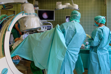 urologist performs a renal endoscopy with an X-ray machine in an operating room