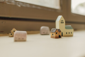 Tiny simple resin houses decorated on the edge of windows.