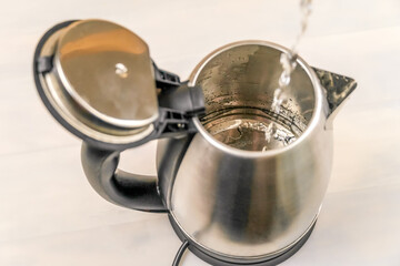 Electric kettle that is filled with water jet, top view
