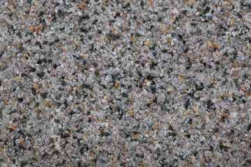 textural plaster of the house wall, colored granite chips, background
