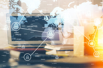 Computer on desktop with social network hologram. Multi exposure. Concept of international people connections.