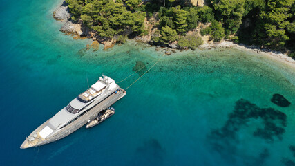 Aerial drone photo of luxury yacht anchored in tropical exotic island bay with turquoise sea